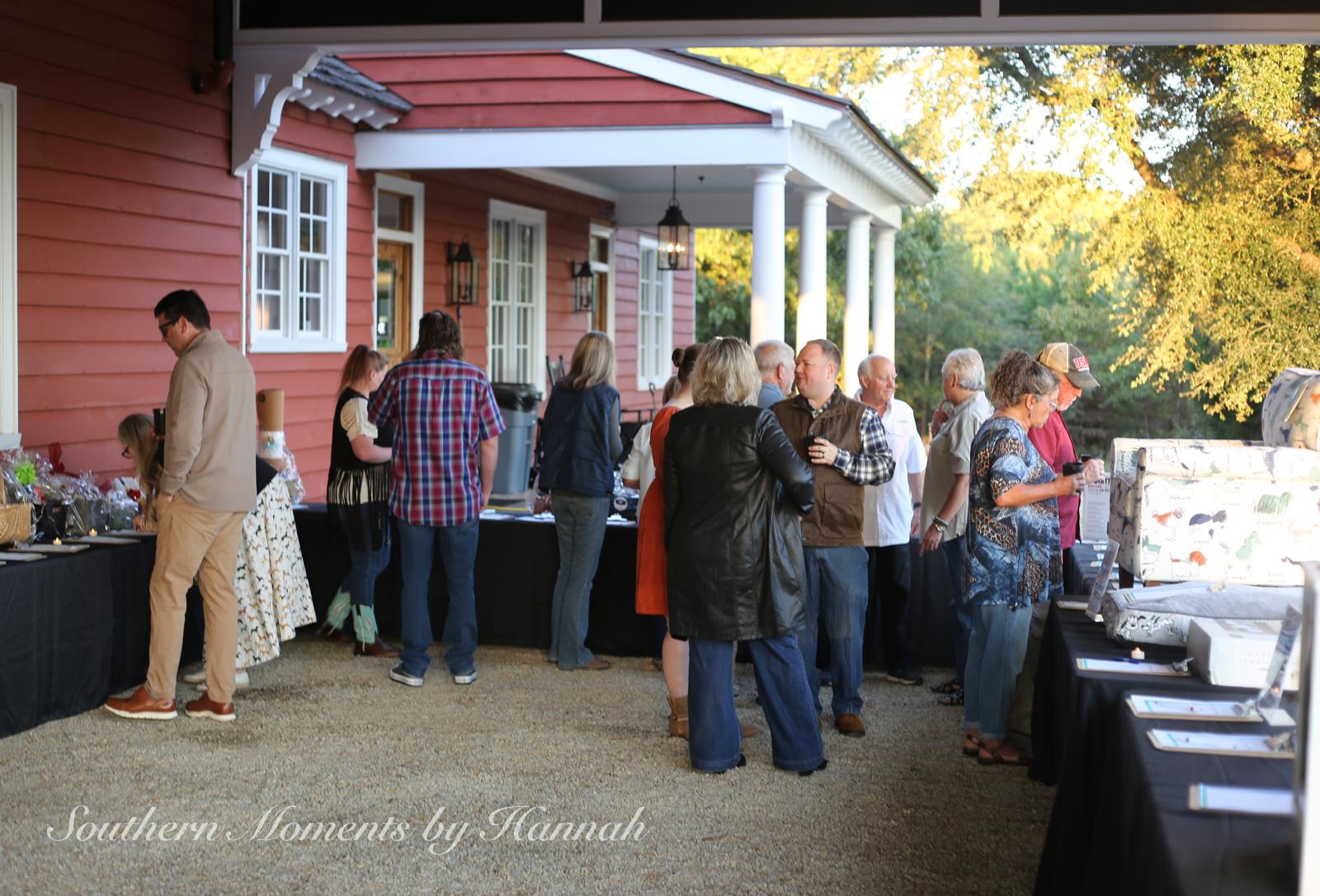 Guests browsing silent auction items at the Fostering Foster Barn Dance