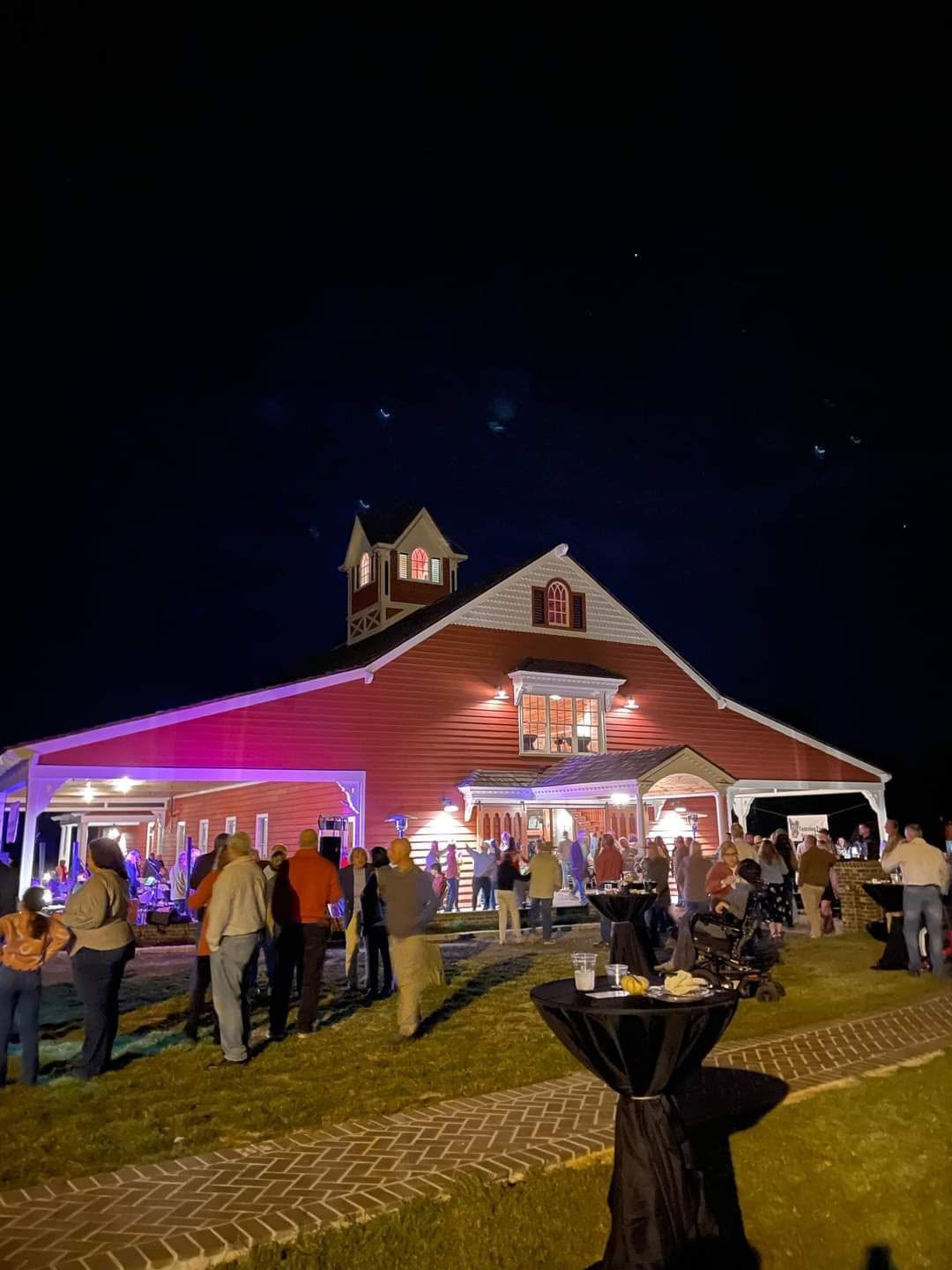 Guests enjoying the Fostering Foster Barn Dance outside The Bock Estate and Venue at night